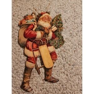 1985 MERRIMACK VICTORIAN STYLE DIECUT MOVING EYE SANTA WITH TOYS SELIGH ORNAMENT